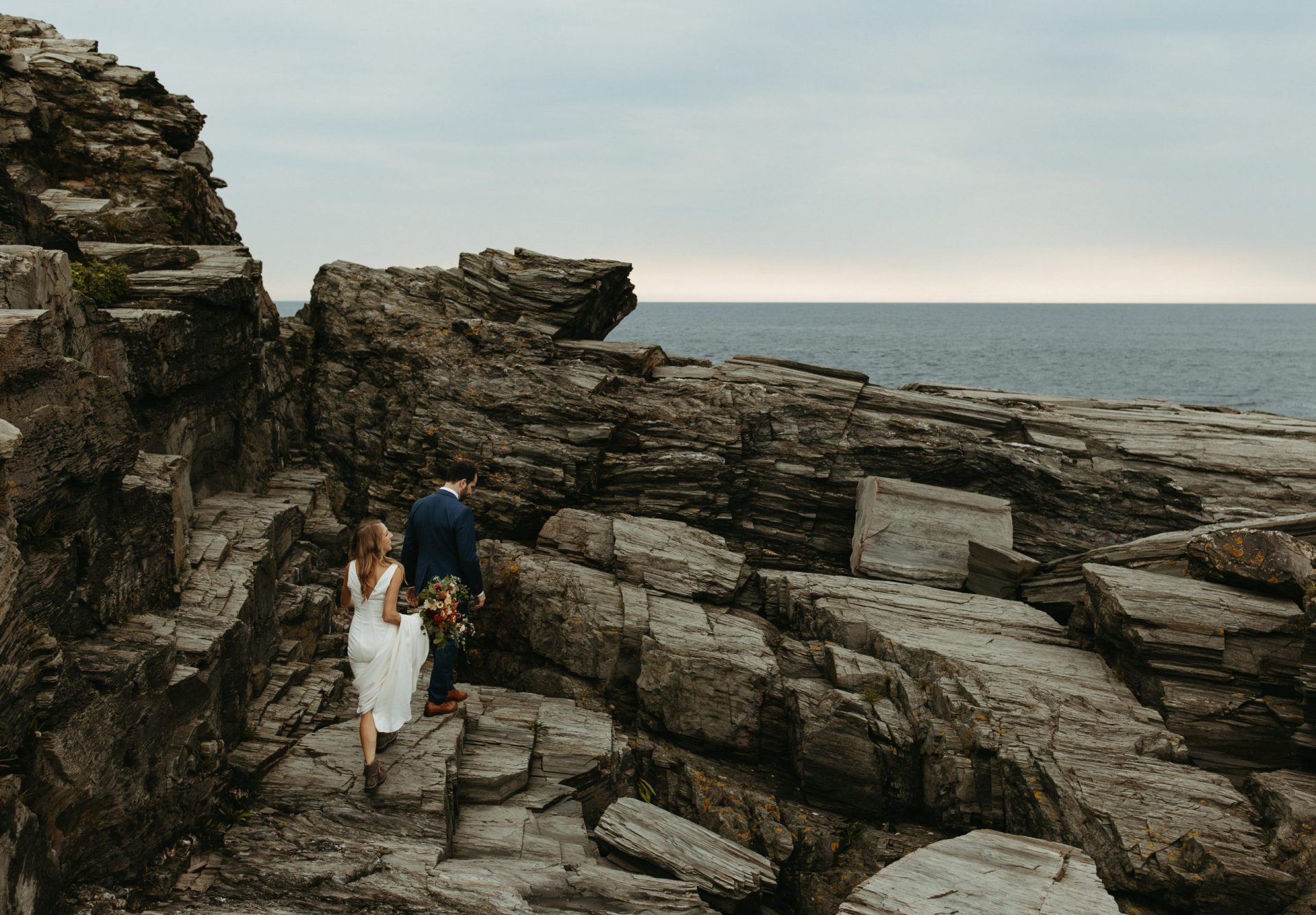 A couple climbs the cliffs for their Two Lights State Park elopement