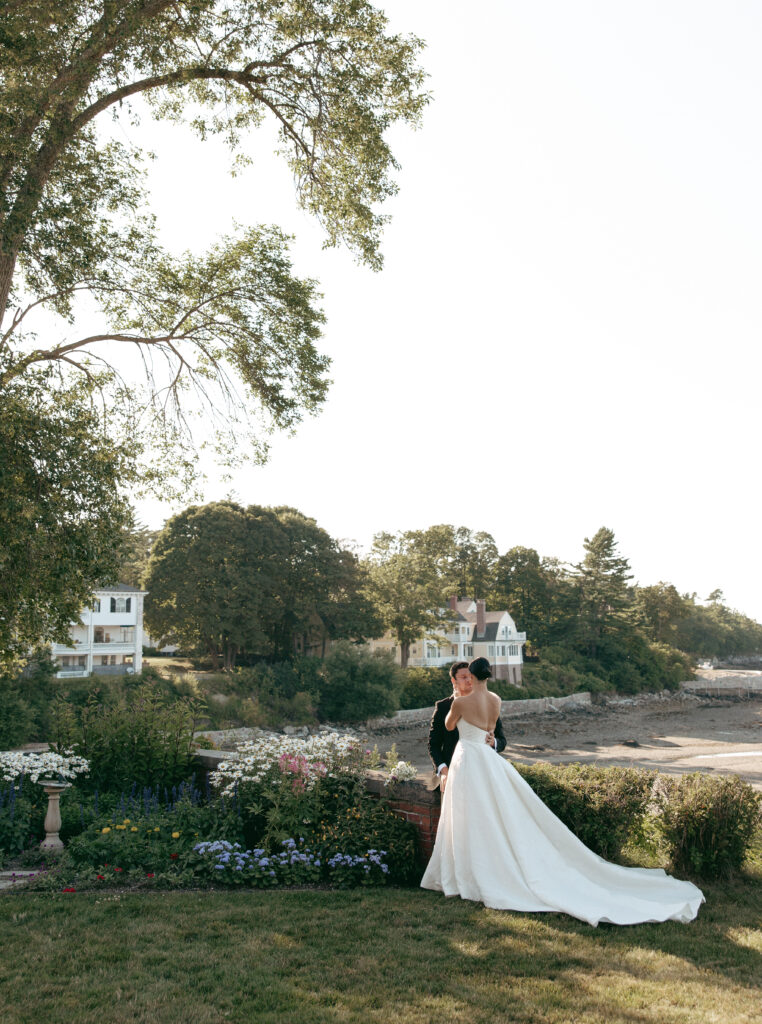 couple in the garden by the ocean at Bar Harbor estate wedding at La Rochelle
