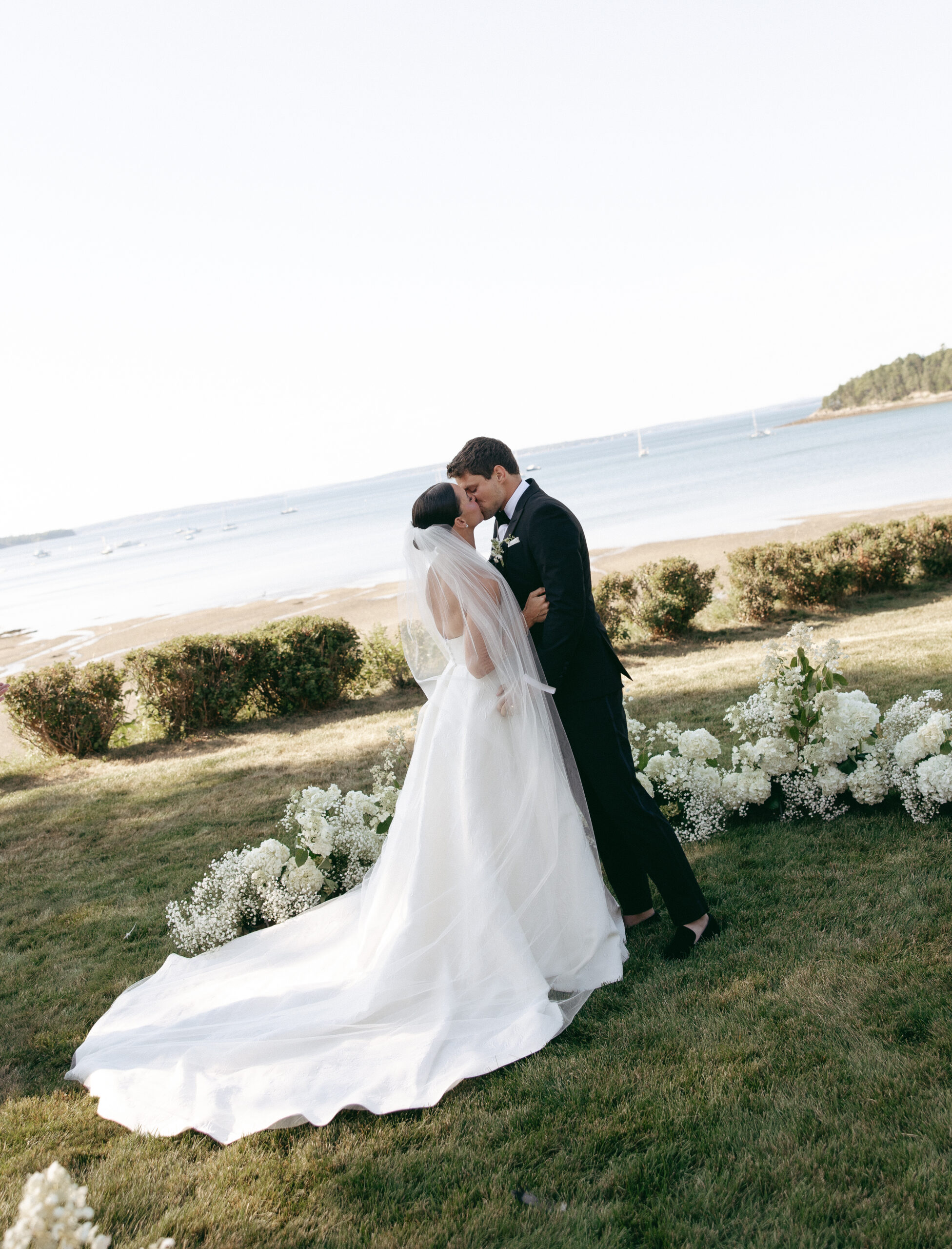couple shares their first kiss at their Maine estate wedding at the Bar Harbor Historical Society