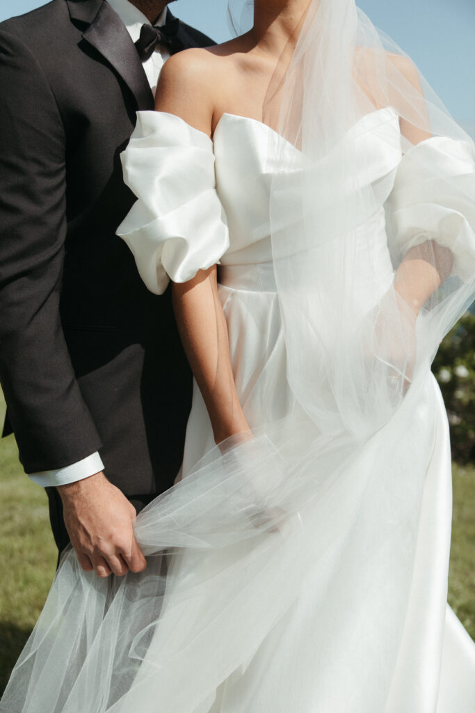 the couple shows off their modern wedding attire at their coastal maine wedding
