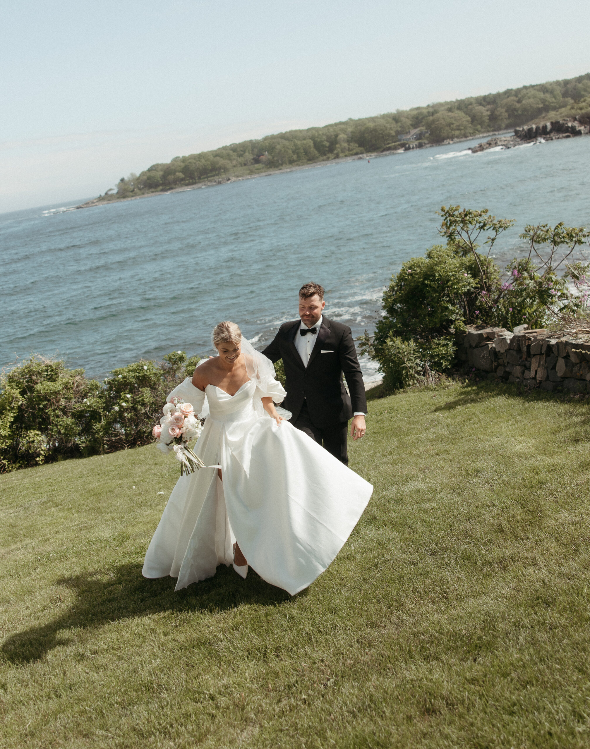 the couple in modern bridal attire heads to their reception at their coastal Maine wedding